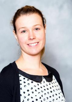 Young woman with fair skin in black and white top, portrait photo of Annick Anctil 