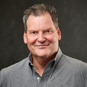 Head shot image of Lee Cox, fair complection, brown hair in button up shirt