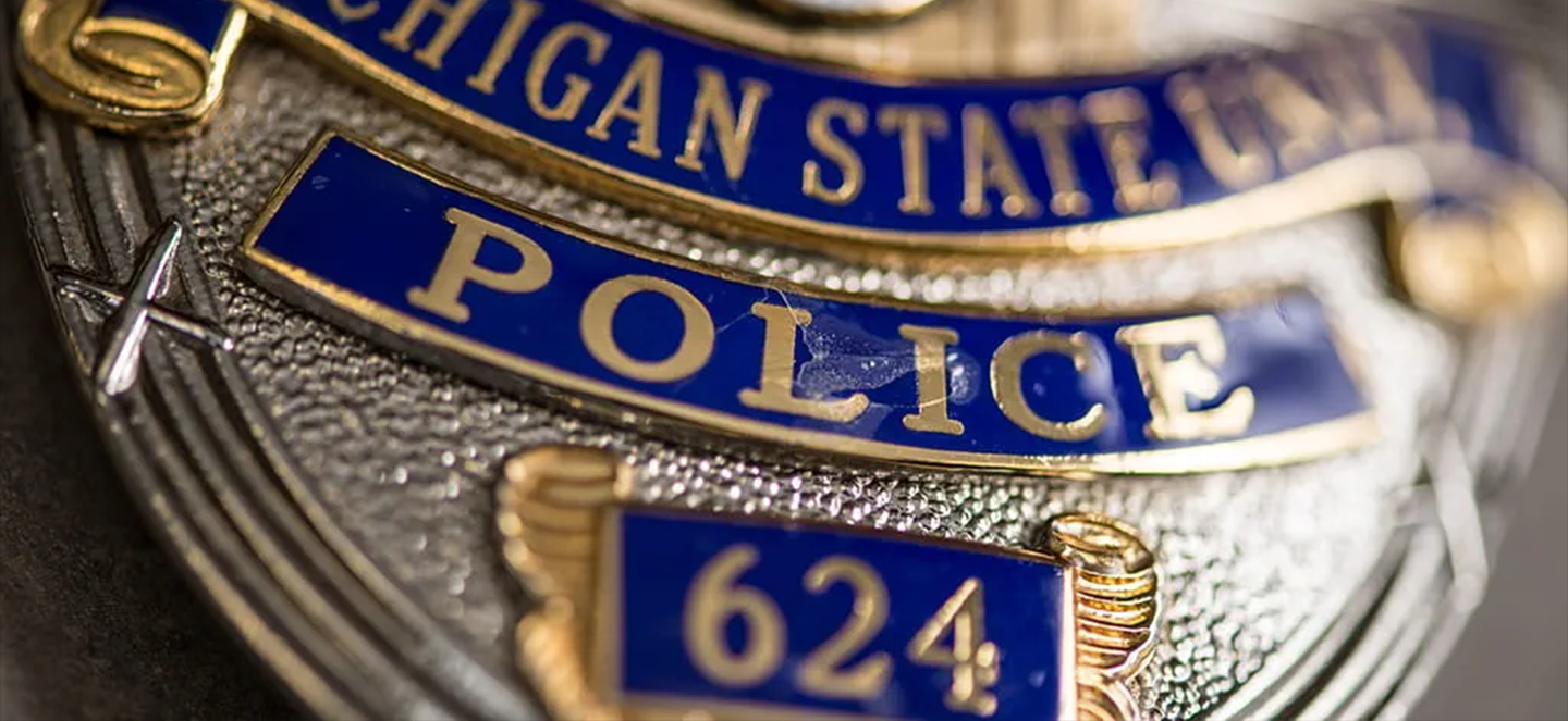 Close up picture of a Michigan State police badge