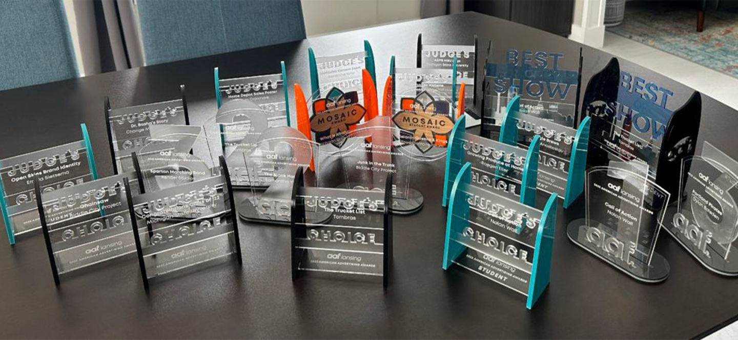 Graphic design awards laid out across a table