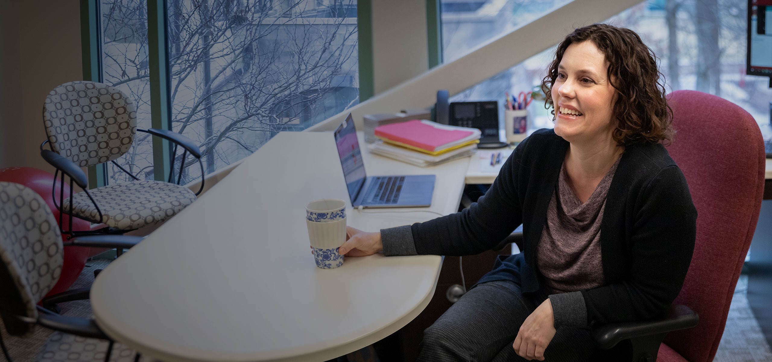 Kay Connelly sitting at a desk.