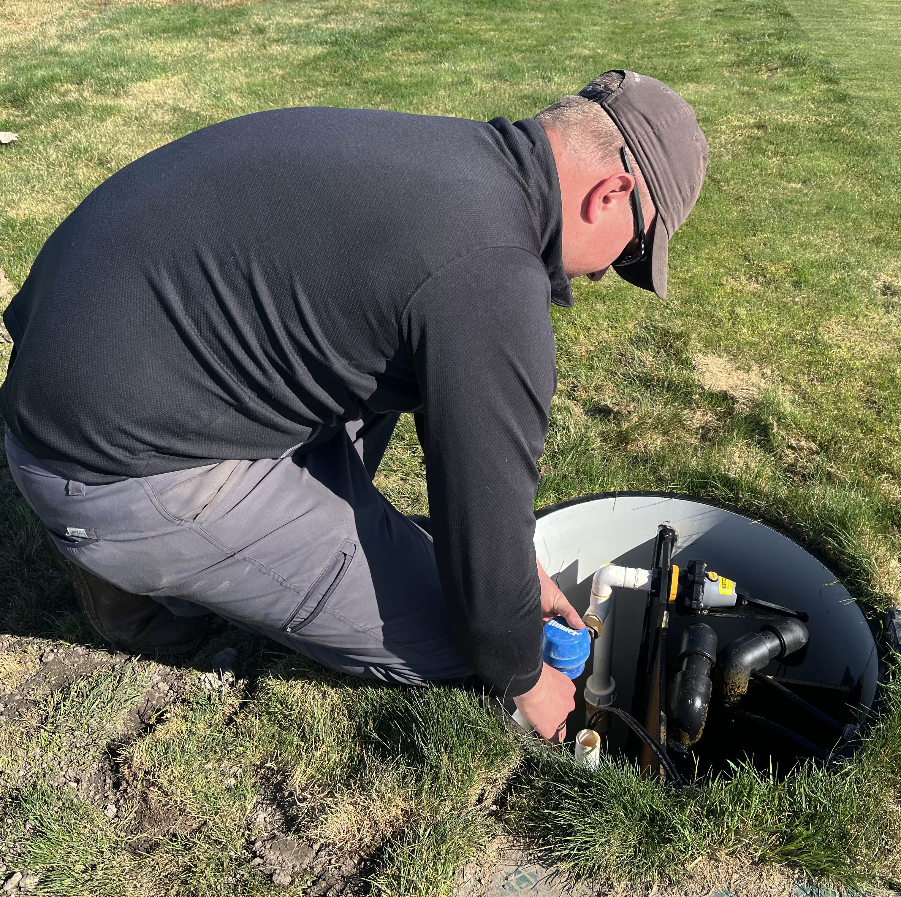 A man working on hydroponics for a golf course