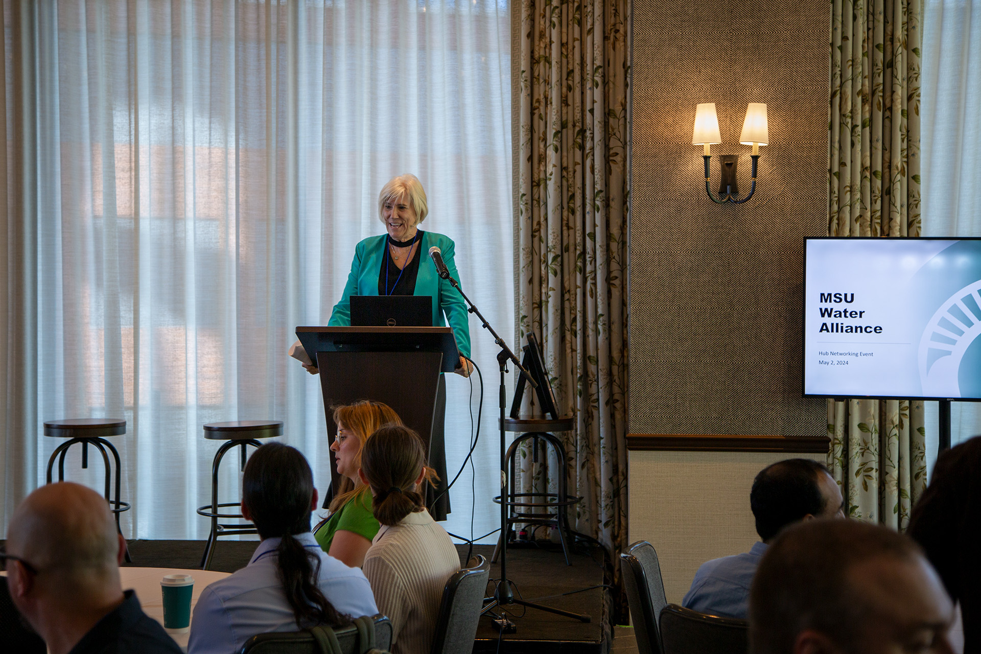 Water Alliance Director Joan Rose greets attendees at the Water Alliance hub networking event.