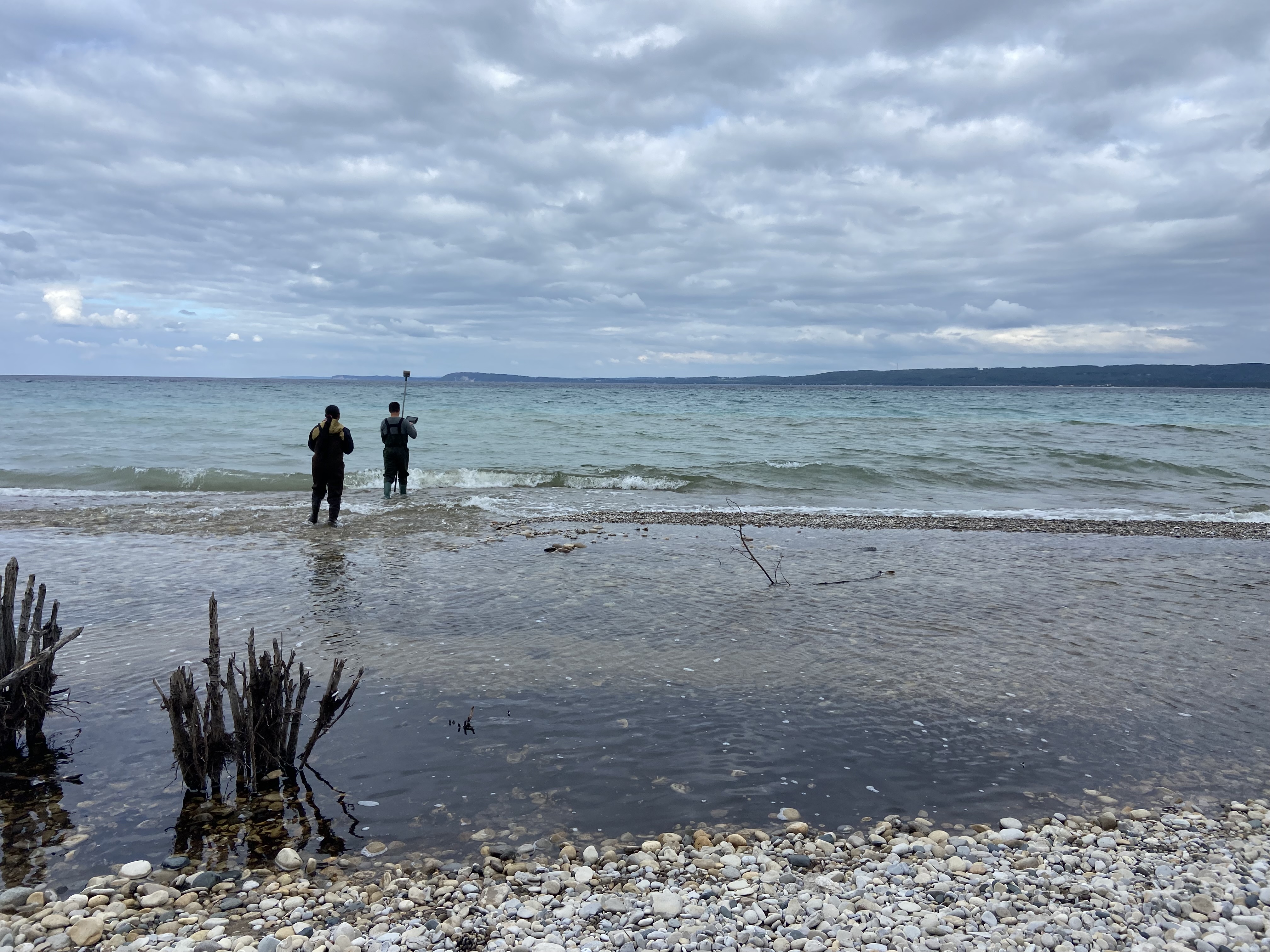 People standing on the shoreline of lake Michigan