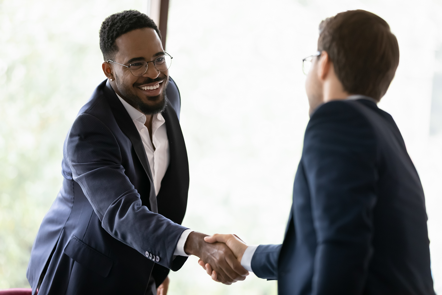 Two people shaking hands with each other