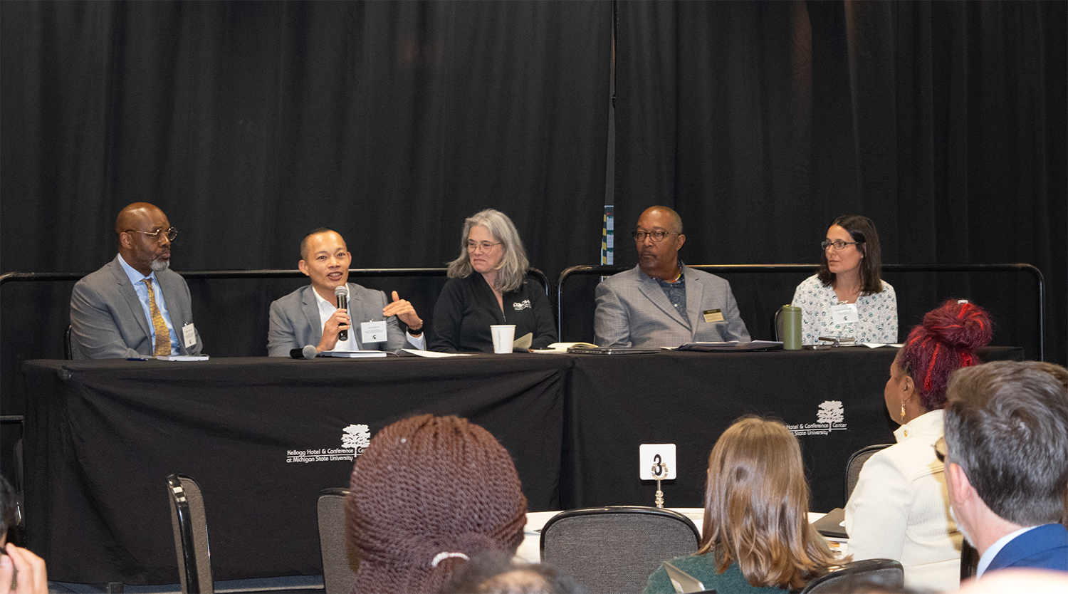 A panel discussion with five panelists. 