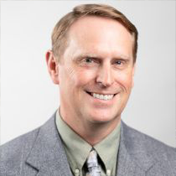 Eric Kasten Posing for Headshot in a Suit