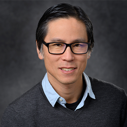 Eric Torng Posing for Professional Headshot Wearring Glasses and a Polo