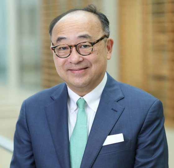 Charles Hong in a suit posing for a professional headshot