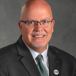 George Smith Smiling For Professional Headshot Wearing a Suit