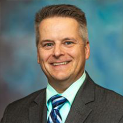 John Goudreau Posing for Professional Headshot in Suit