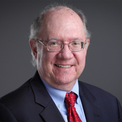 John Hollenbeck Posing for Headshot in a Suit