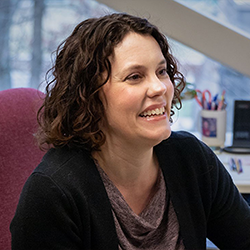 Kay Connelly Posing for Headshot in a Office