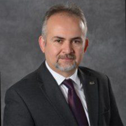 Muhammed Kutay in a Suit Posing for Headshot