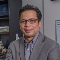 Robert Brathwaite Posing for Headshot in a Office