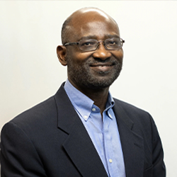 Titus Awokuse Posing For Headshot in a Suit