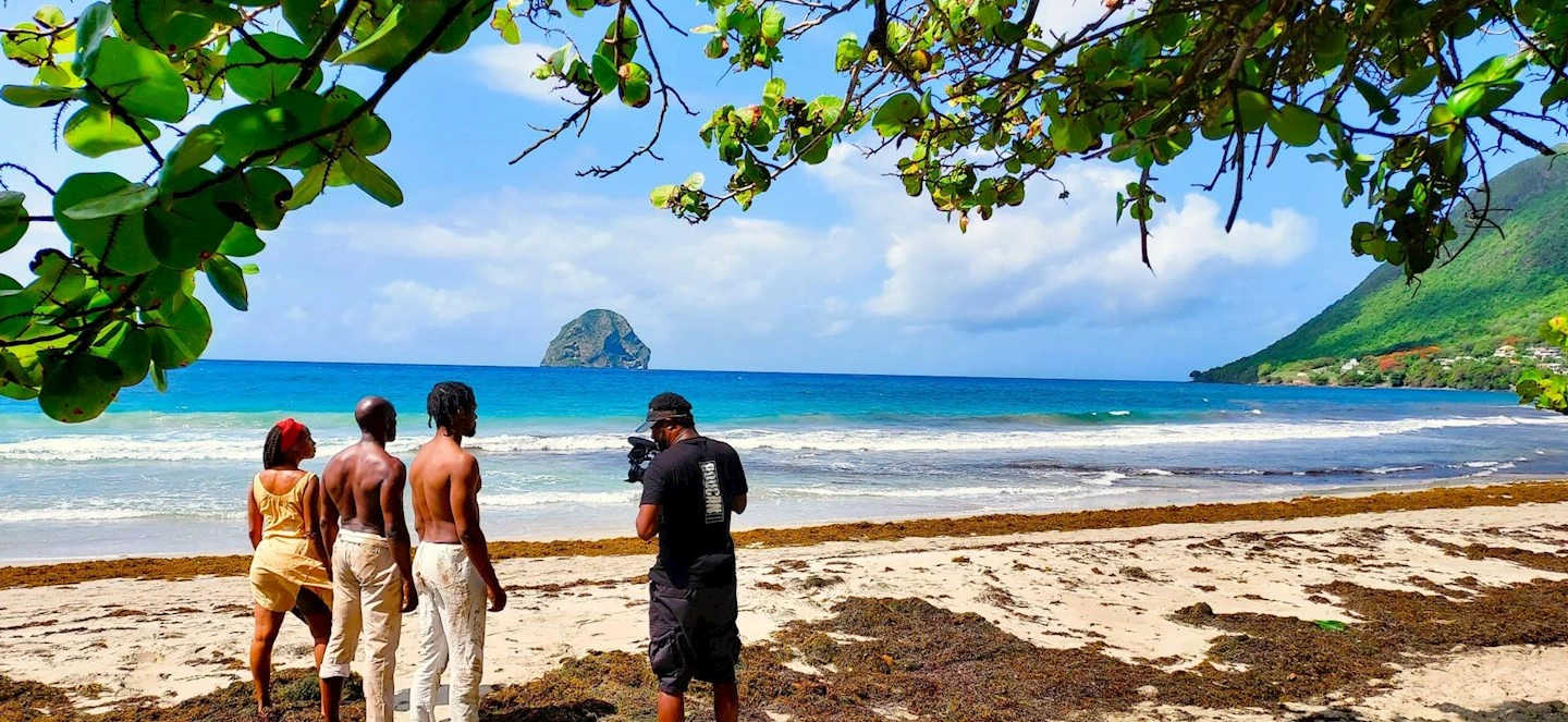 4 people standing near a beach on a sunny day