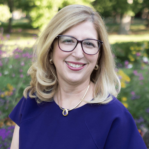 Teresa Woodruff smiling posing for professional photo in nature