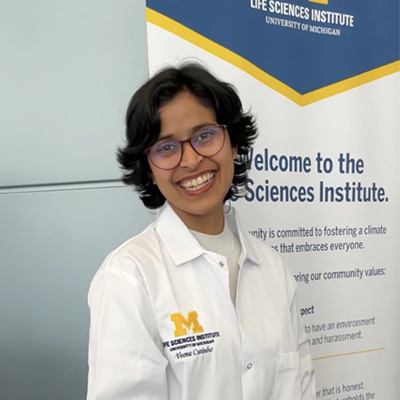 Veona Cutinho smiling wearing a lab coat