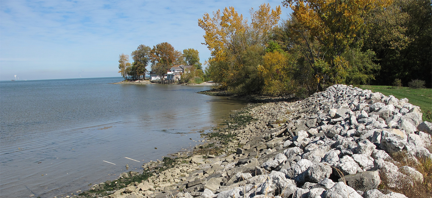 Autumn lakeshore with rocky embankment