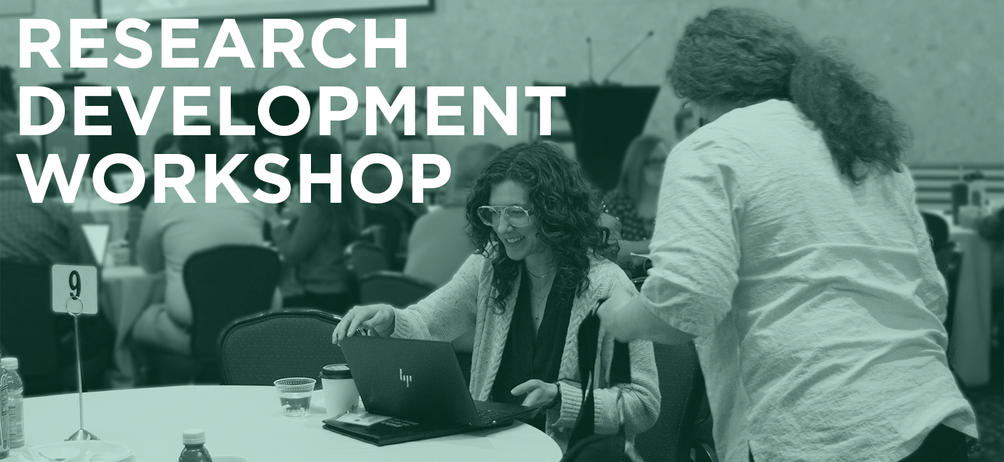Two people with long curly hair, at table. One person at the table is smiling and opening a laptop, the other person has their back facing the viewer. "Research Development Workshop" is overlaid on the photo. 