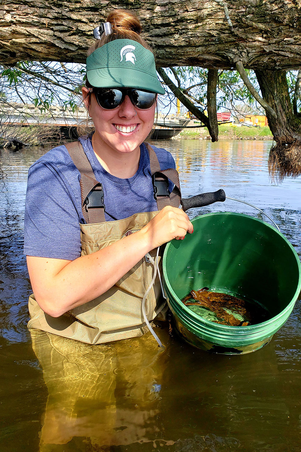 Kanda Cerel holding bucket of lamprey
