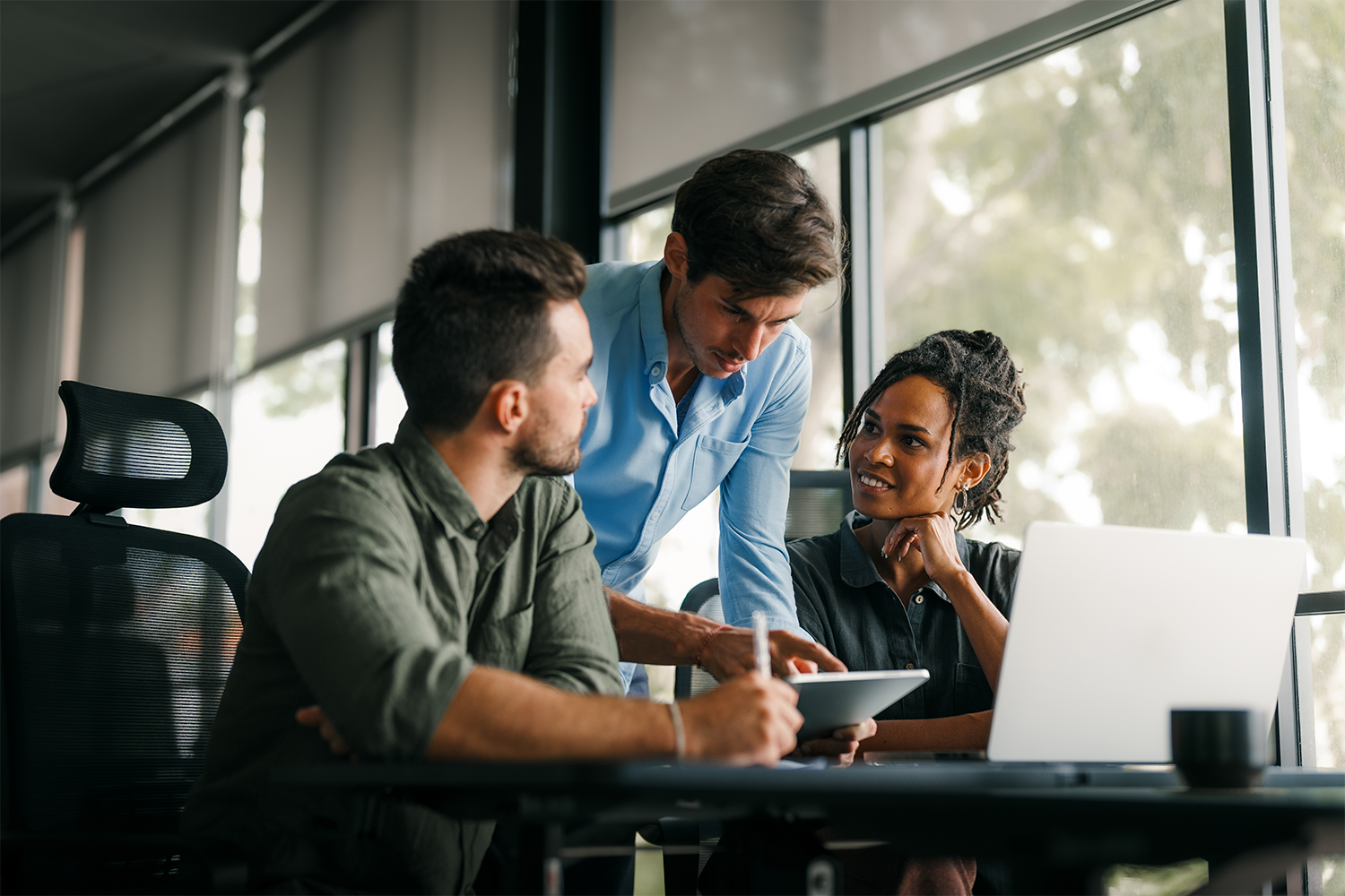 A group of people working together at a desk
