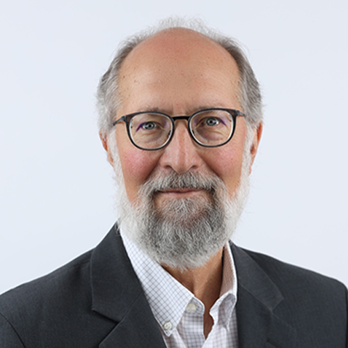 Doug Buhler headshot in suit coat and glasses