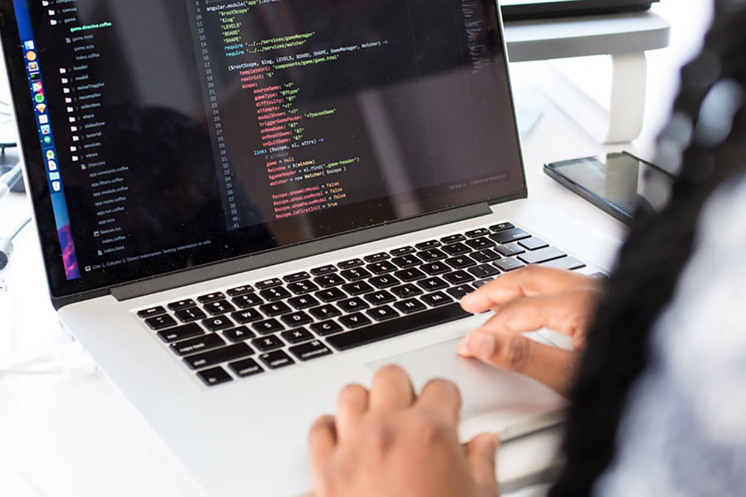 Person's hands working on laptop