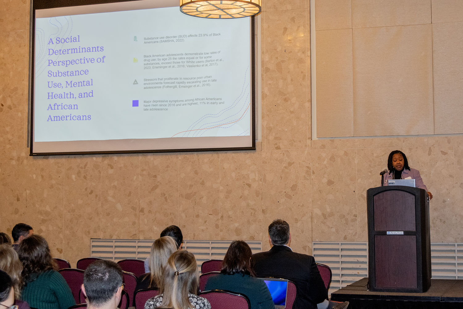 person giving a presentation in front of several people