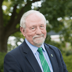 Norm Graham Posing for Professional Headshot in Suit