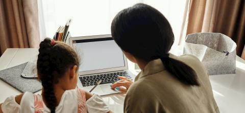 Mother and daughter using computer