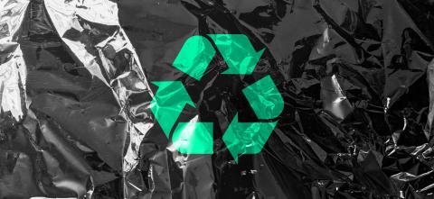 Recycle symbol on a black garbage bag