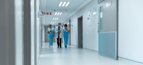 Doctor and Two nurses walking down a hospital hallway