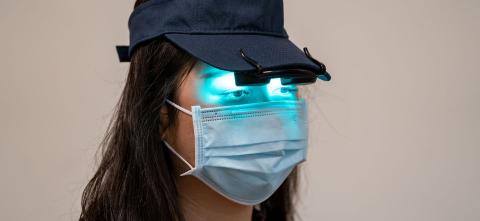 Light threapy visor on person wearing a mask