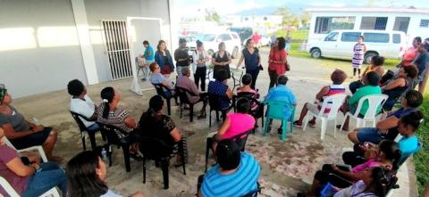 Group of 6 women researchers from MSU talking to a community group in Puerto Rico