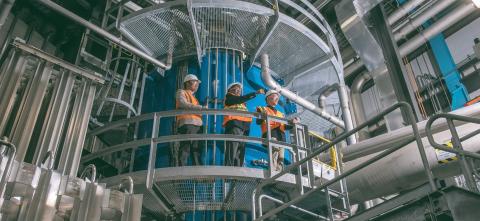 Three people touring the Facility for Rare Isotope Beams