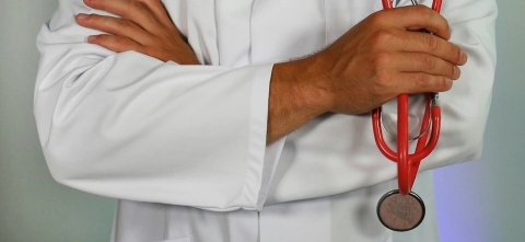 A doctor in their whitecoat with a stethoscope