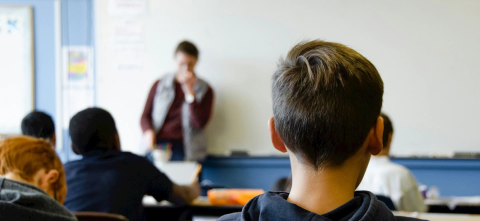 The back of a students head in a classroom