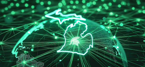 A generated image of Michigan made out of a netowrk of lights, with the Michigan State Spartan logo in the center