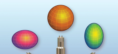 Illustration showing three colorful grid-lined 3D shapes representing exotic atomic nuclei