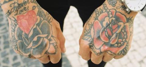 Two fisted hands showing off tattoos