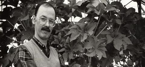 Chris Somerville posing near plants