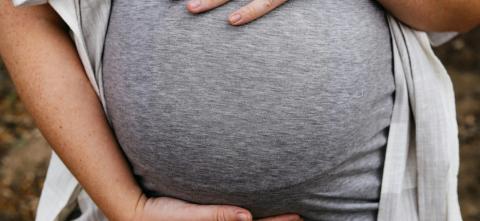 Pregnant woman holding belly