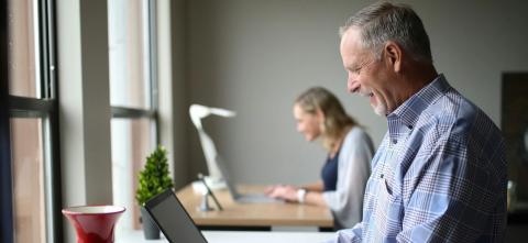 Two people using laptops
