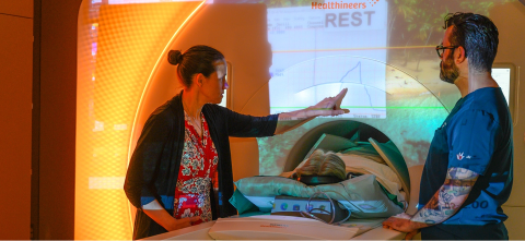 Researchers assisting a patient during an MRI scan using advanced medical imaging technology.