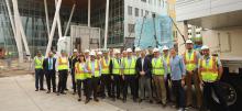 Group of people in construction hats celebrating new building