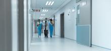 Doctor and Two nurses walking down a hospital hallway