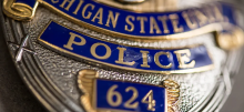 Close up picture of a Michigan State police badge
