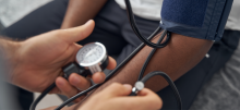 A close up image of someone getting their blood pressure taken